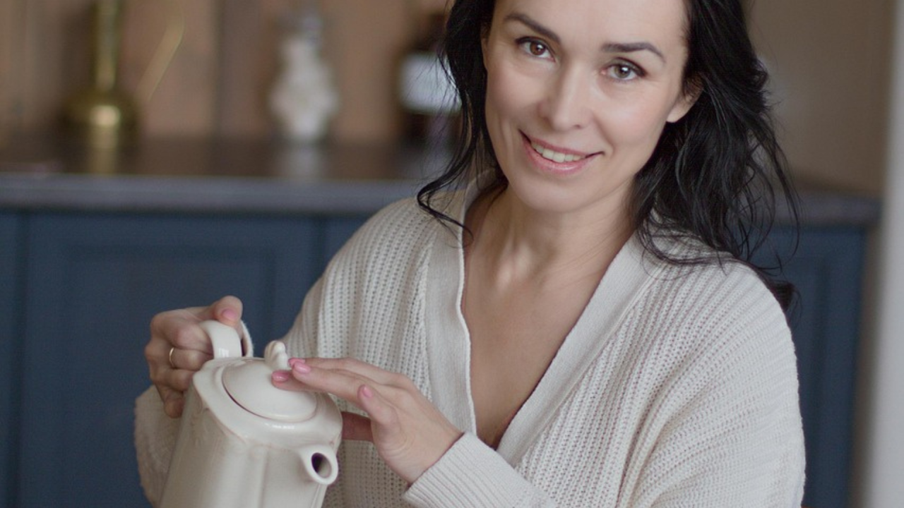 woman pouring tea and smiling